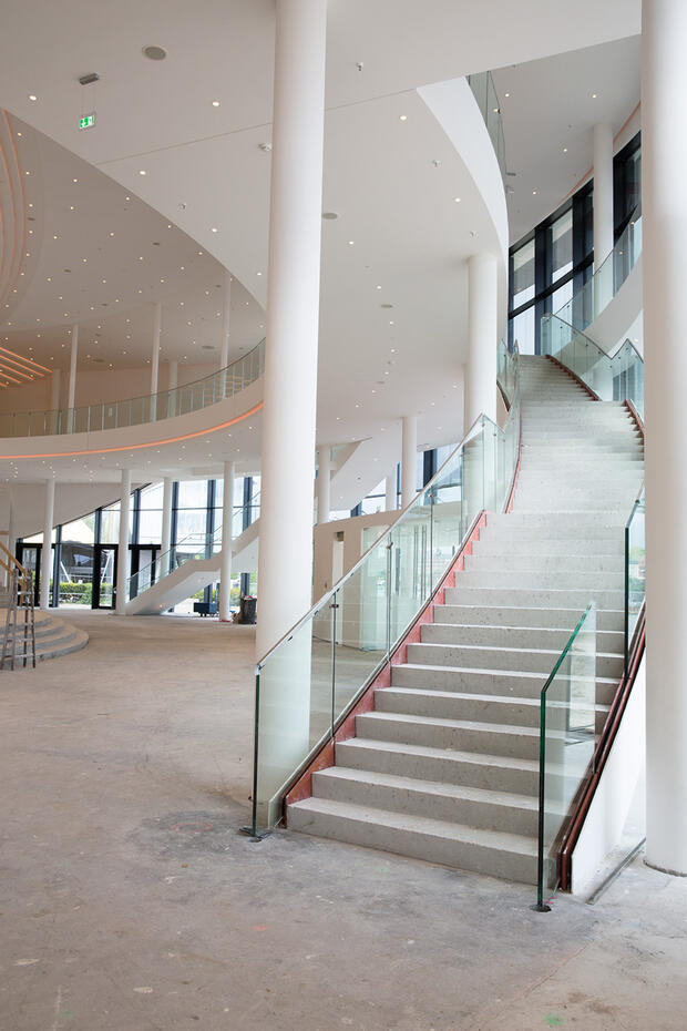 Sichtbeton und schwebende Treppenanlage im Foyer